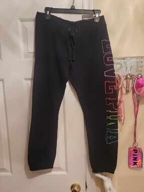 Pink Victorias Secret Black Joggers. Left Leg Has Vibrant Colors Outling Letters